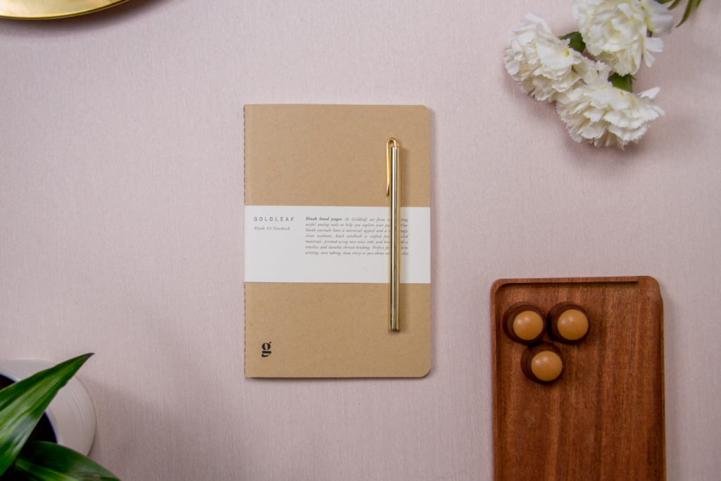 gold leaf notebook on a pink background